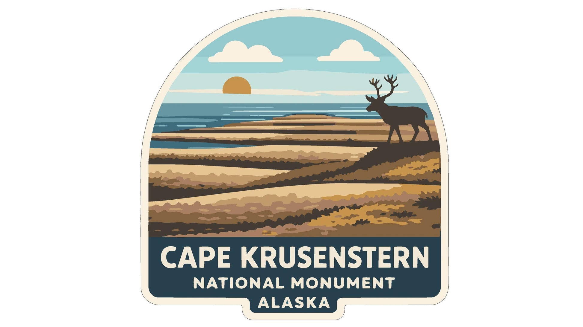 a sticker or emblem with a scenic landscape and a deer in the background, along with the text "CAPE KRUSENSTERN NATIONAL MONUMENT ALASKA".