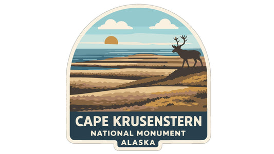 a sticker or emblem with a scenic landscape and a deer in the background, along with the text "CAPE KRUSENSTERN NATIONAL MONUMENT ALASKA".
