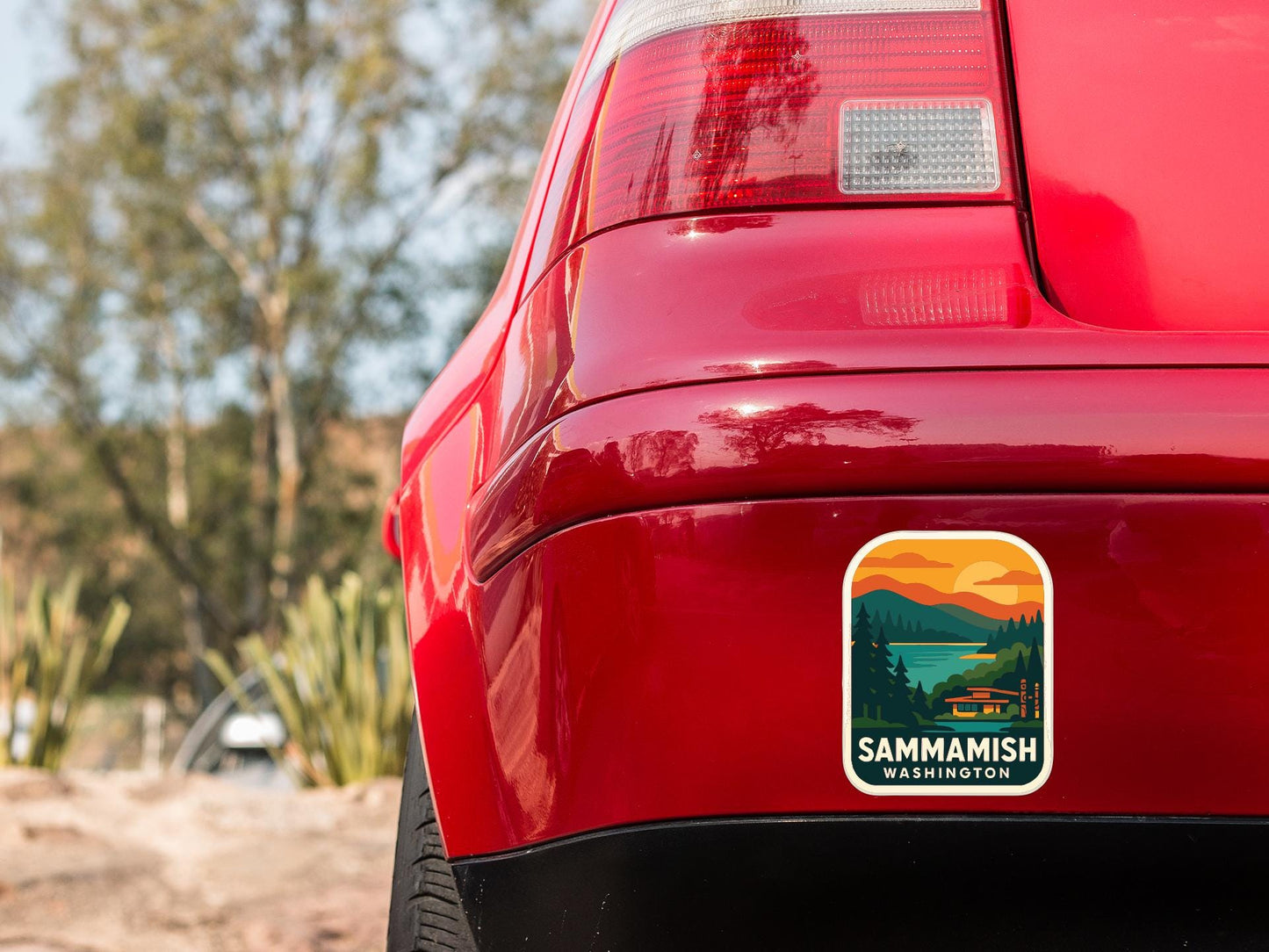 the rear end of a red car with a sticker on the back window that says "SAMMAMISH WASHINGTON".