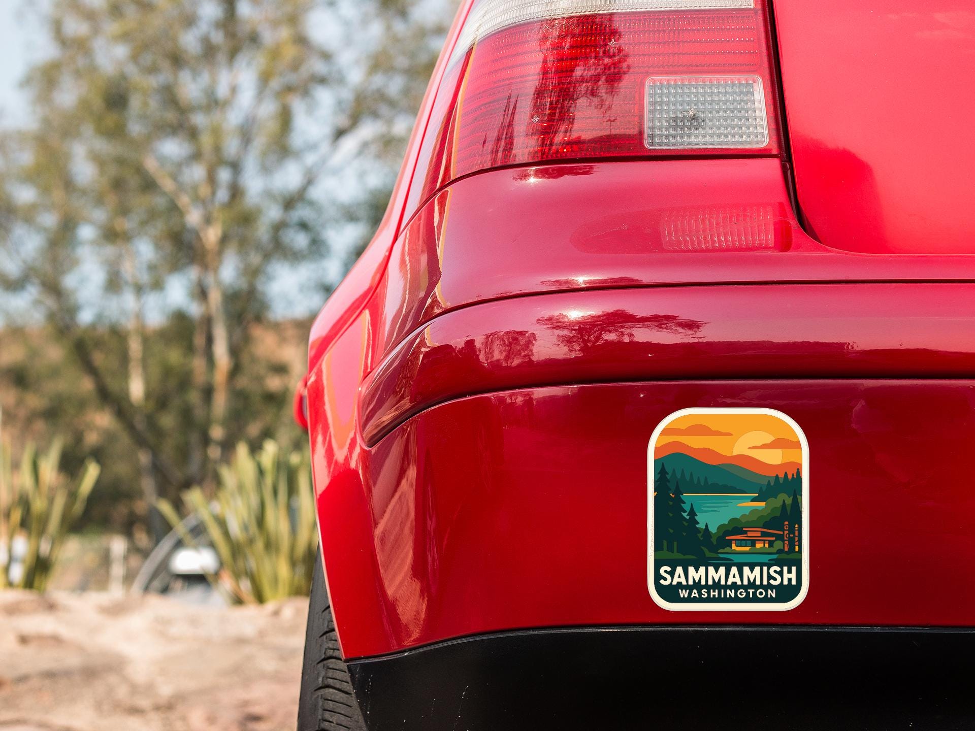 the rear end of a red car with a sticker on the back window that says "SAMMAMISH WASHINGTON".