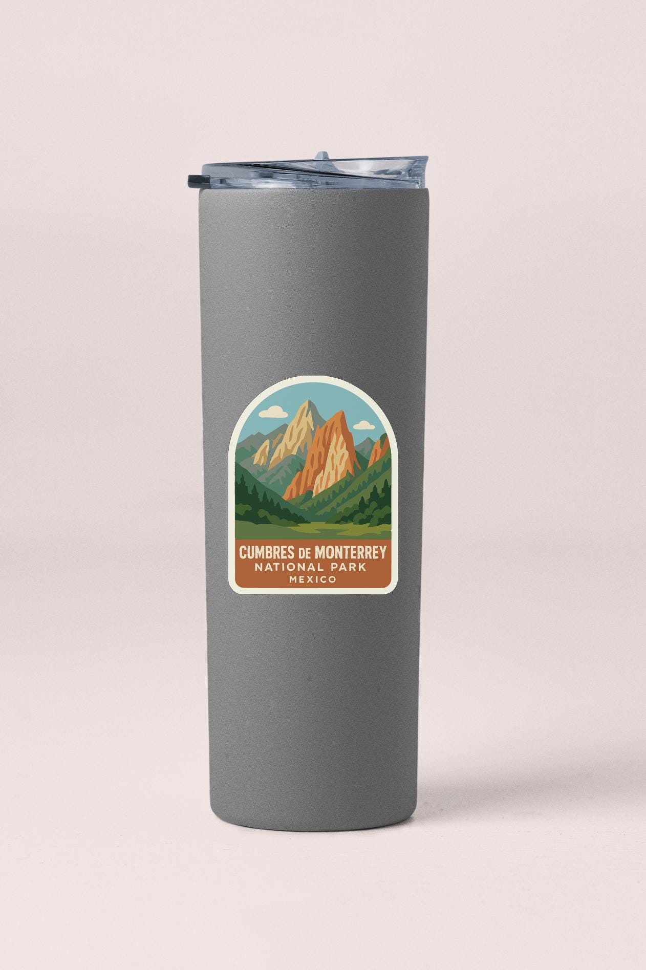 A gray insulated tumbler with a label that says "Cumbres de Monterey National Park Mexico".