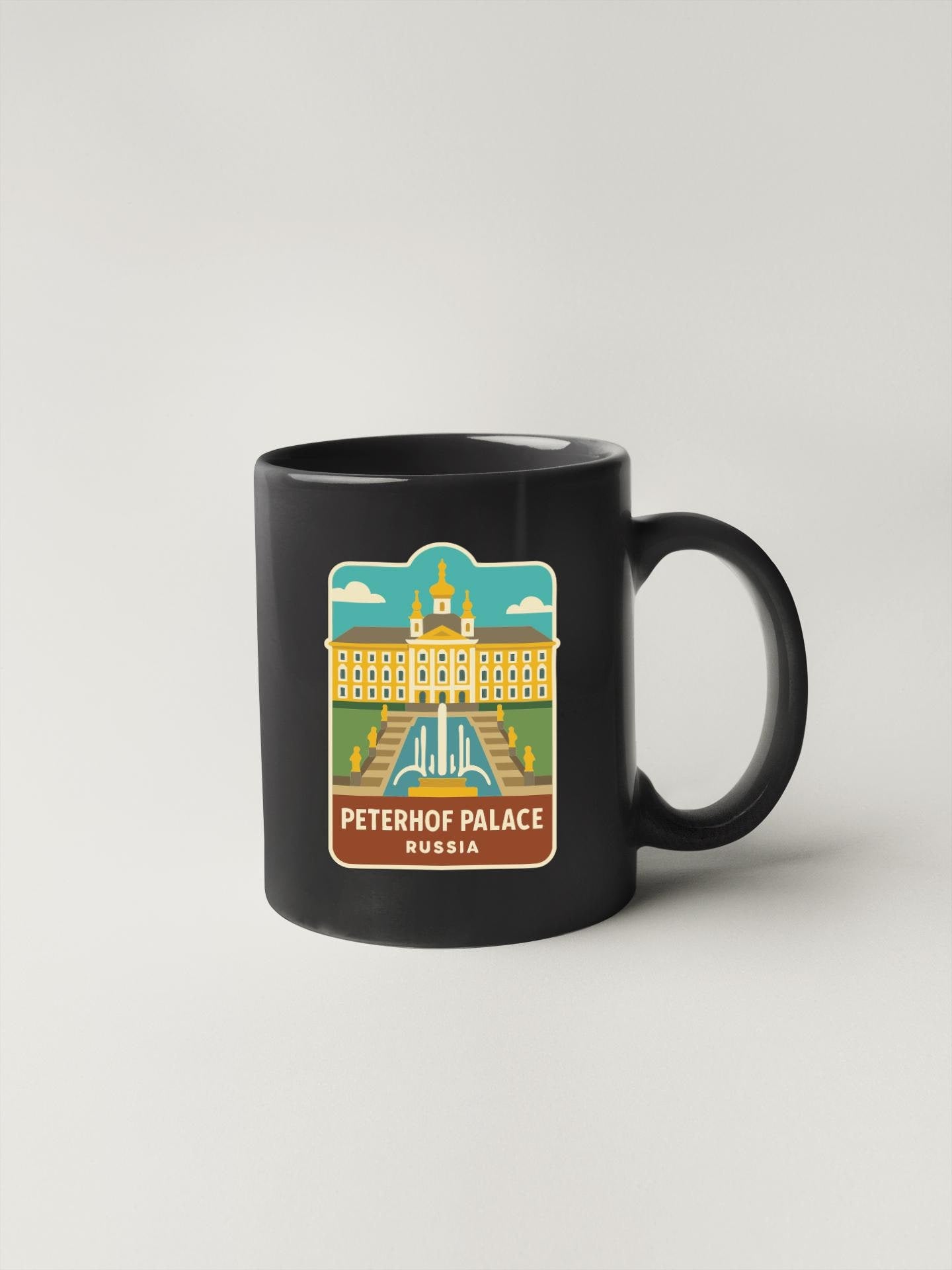 A black coffee mug with a graphic design depicting the Peterhof Palace in Russia.