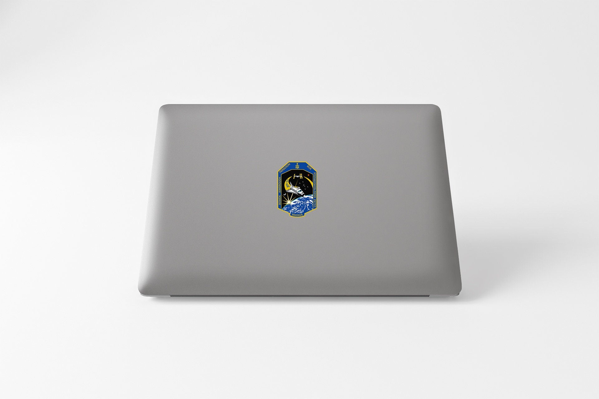 a laptop with a sticker of a person's face