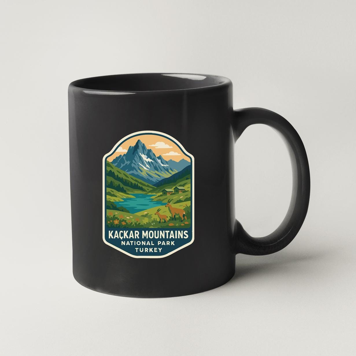 A black coffee mug with a mountain landscape and text that says "Kackar Mountains National Park Turkey".
