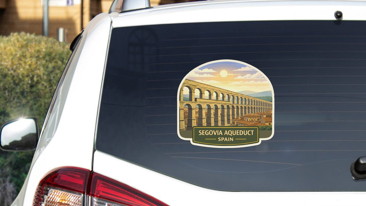 A sticker on the rear window of a car, depicting the Segovia Aqueduct in Spain.