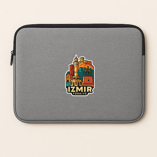 A gray laptop sleeve with a colorful sticker depicting a cityscape of Istanbul, Turkey.