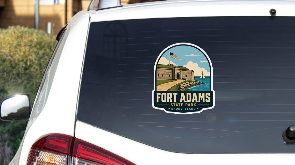 A sticker on the rear window of a white car, depicting a scenic view of Fort Adams State Park in Rhode Island.
