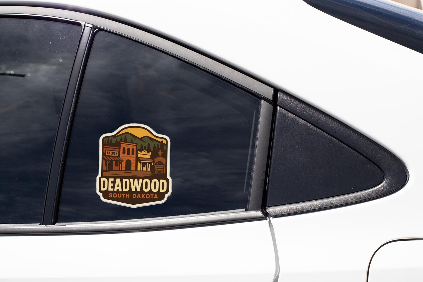 A car window with a sticker that says "Deadwood South Dakota".