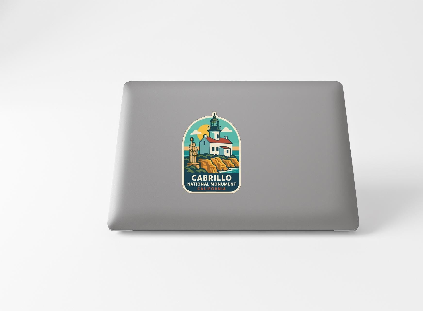 a sticker with a lighthouse and a building, likely representing Cabrillo National Monument.