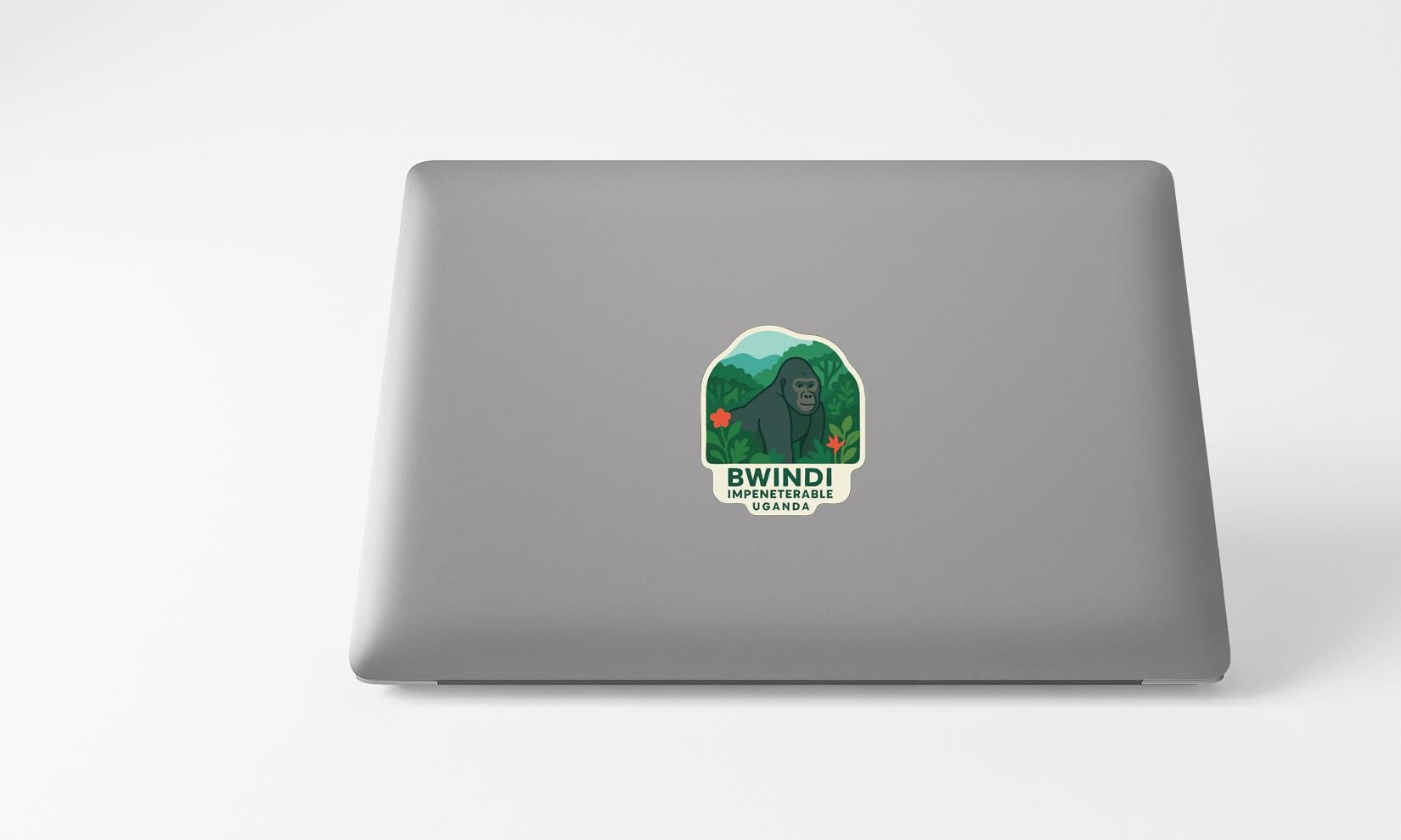 a sticker with a graphic of a gorilla and the text "BWIN! UGANDA" on a laptop.