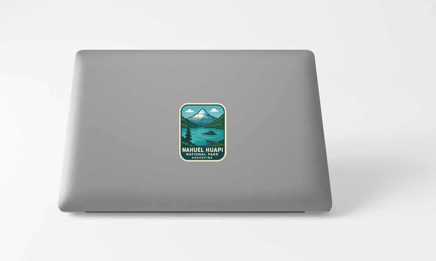 A sticker on the back of a laptop displaying a mountain landscape with a lake.