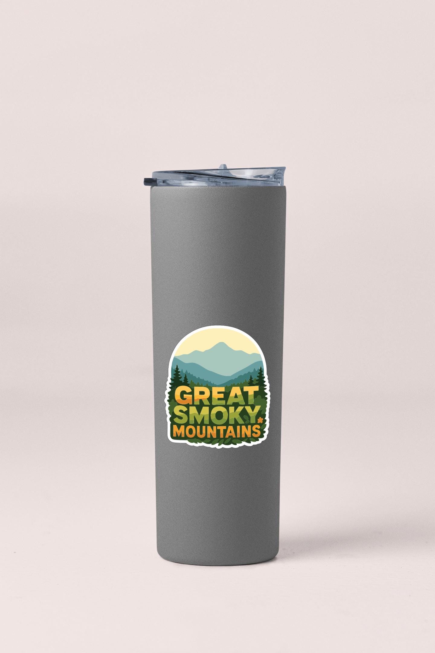 A gray insulated tumbler with a sticker that says "Great Smoky Mountains".
