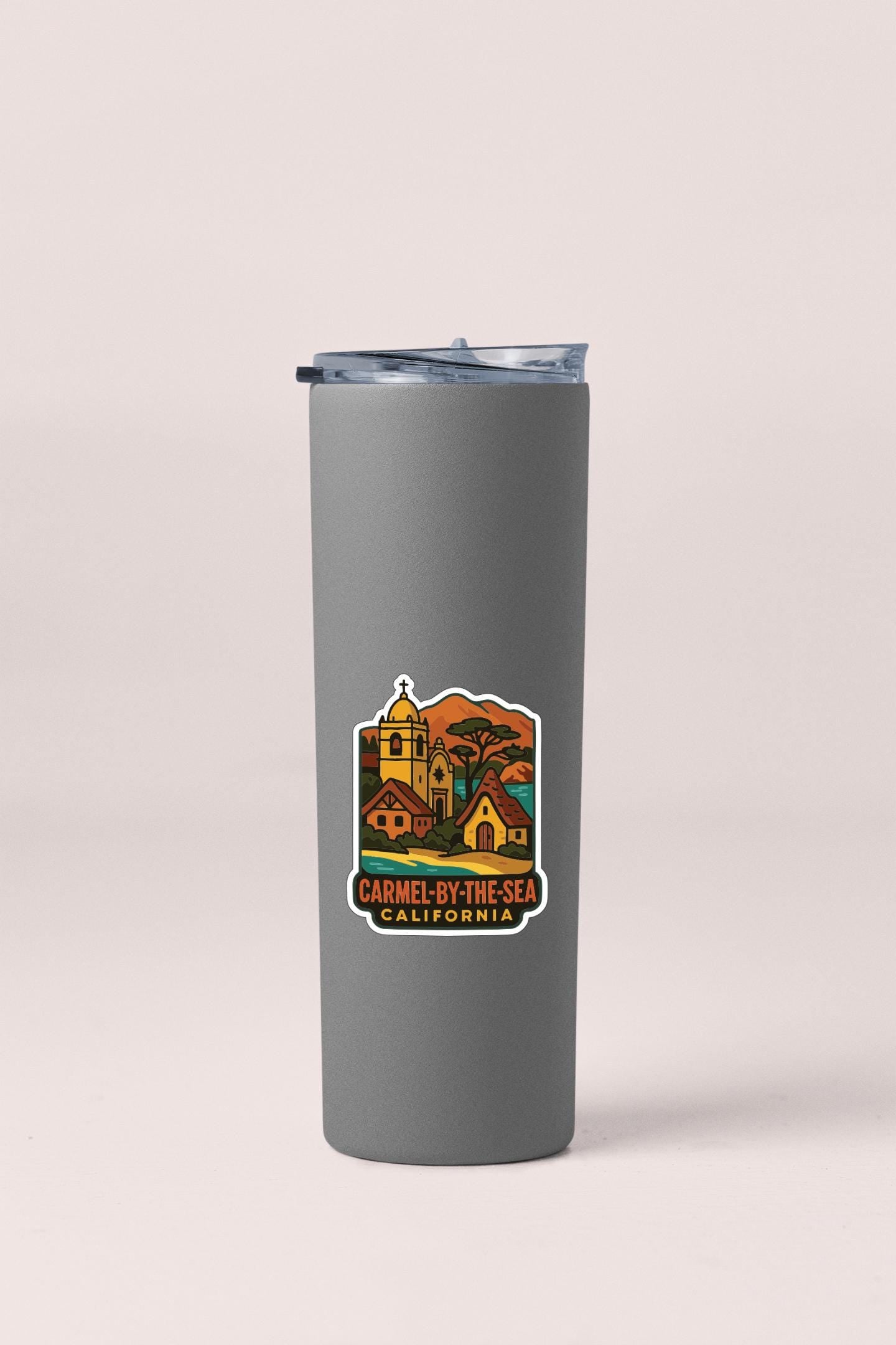 A gray insulated tumbler with a printed label that says "Carmel by the Sea, California".