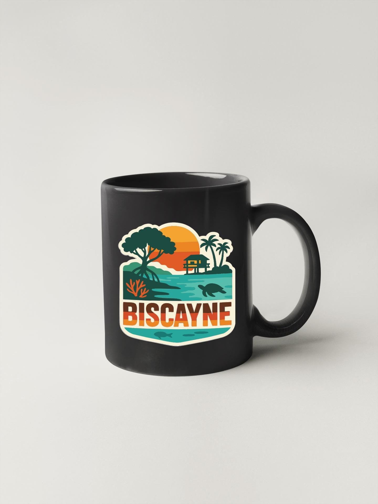 A black coffee mug with a colorful graphic design depicting a tropical beach scene, including palm trees, a sunset, and a turtle.