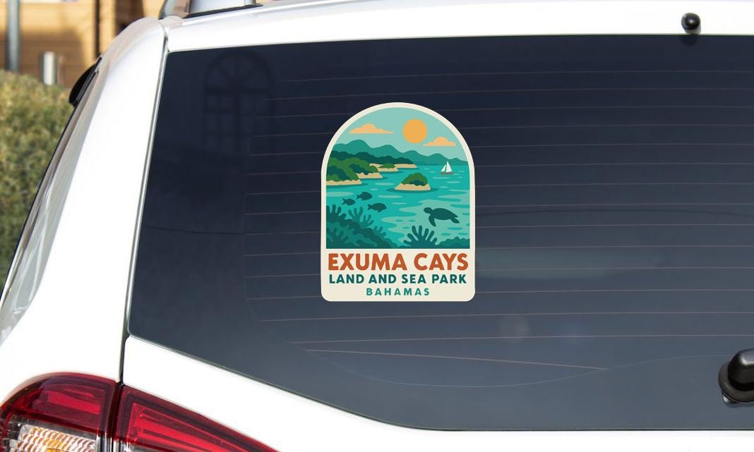 A sticker on the rear window of a car that says "EXUMA CAYS LAND AND SEA PARK BAHAMAS".
