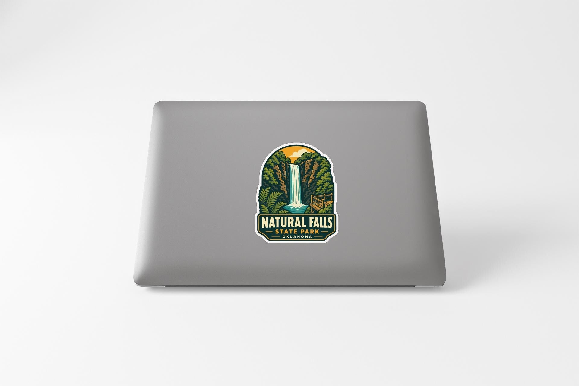 a sticker or decal of Natural Falls State Park on the back of a laptop computer.