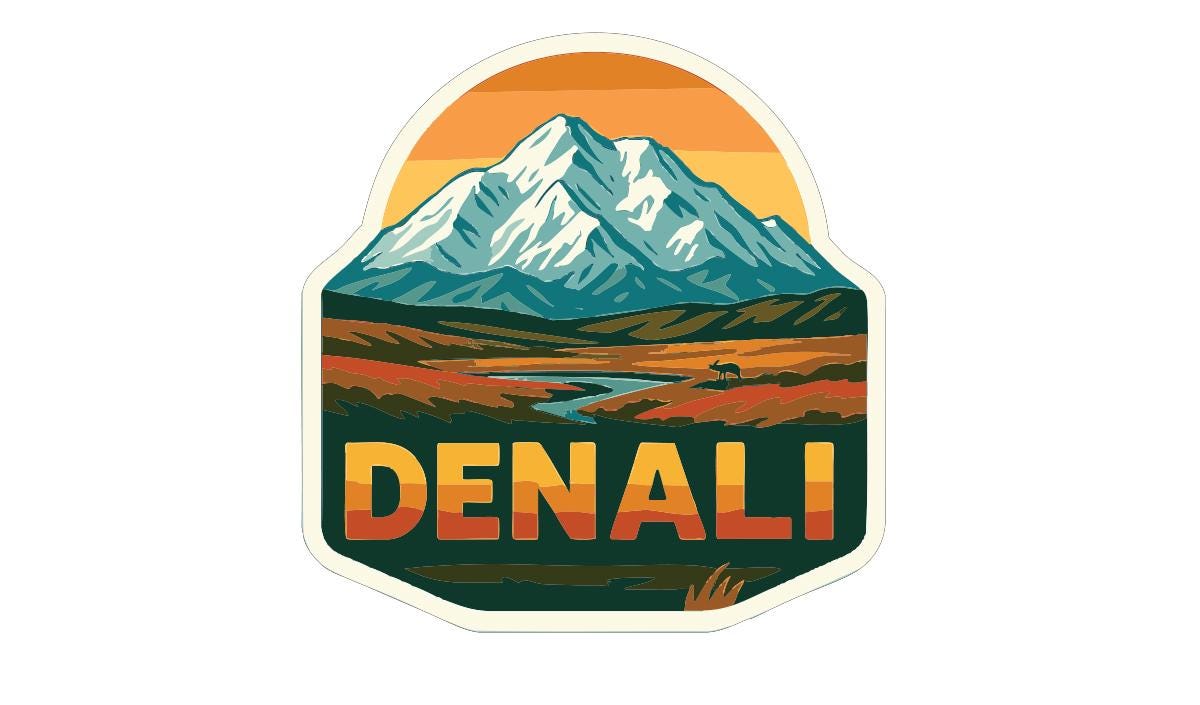 A sticker or emblem featuring a mountain landscape with a river, and the word "DENALI" prominently displayed in the center.