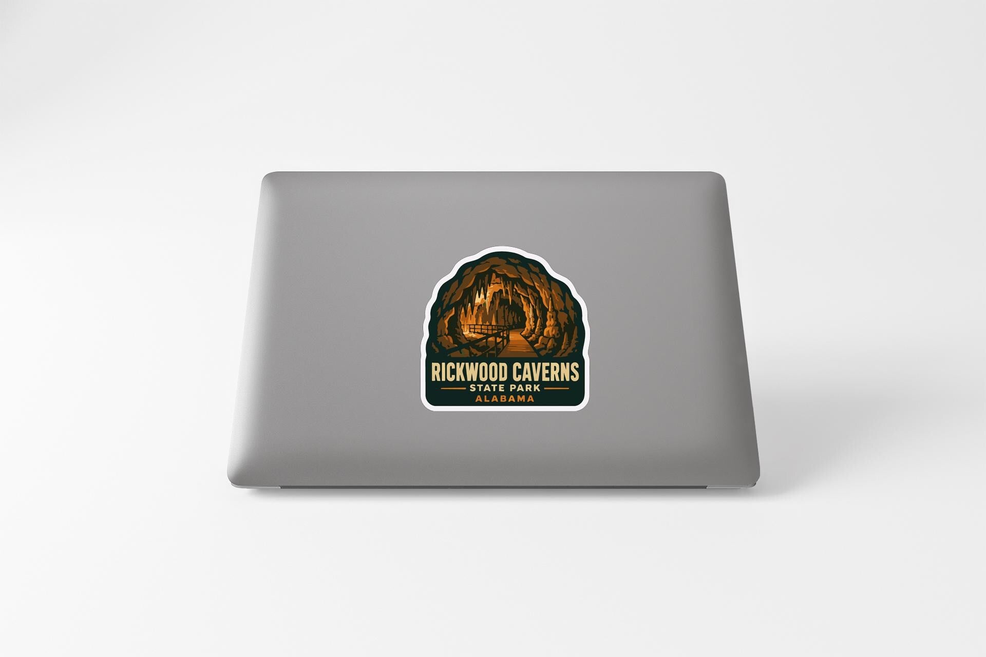 a sticker with a graphic of a cave or rock formation, along with the text "RICKWOOD CAVENS" and "ALASKA" printed on it.