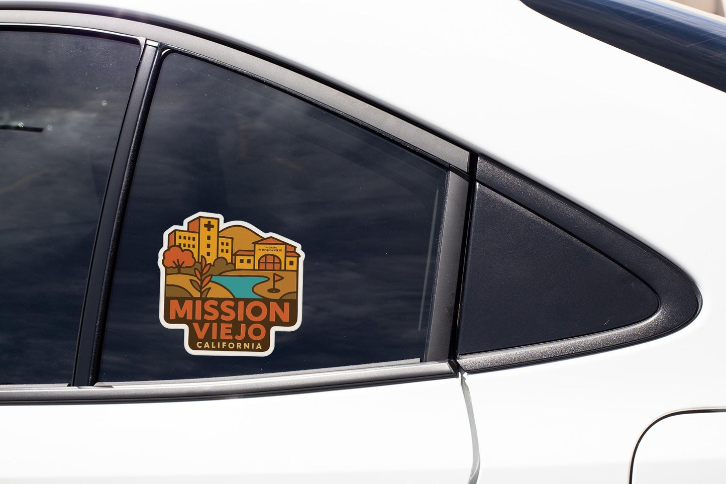 A sticker on the side of a car window, featuring an illustration of a cityscape with buildings and a lake.