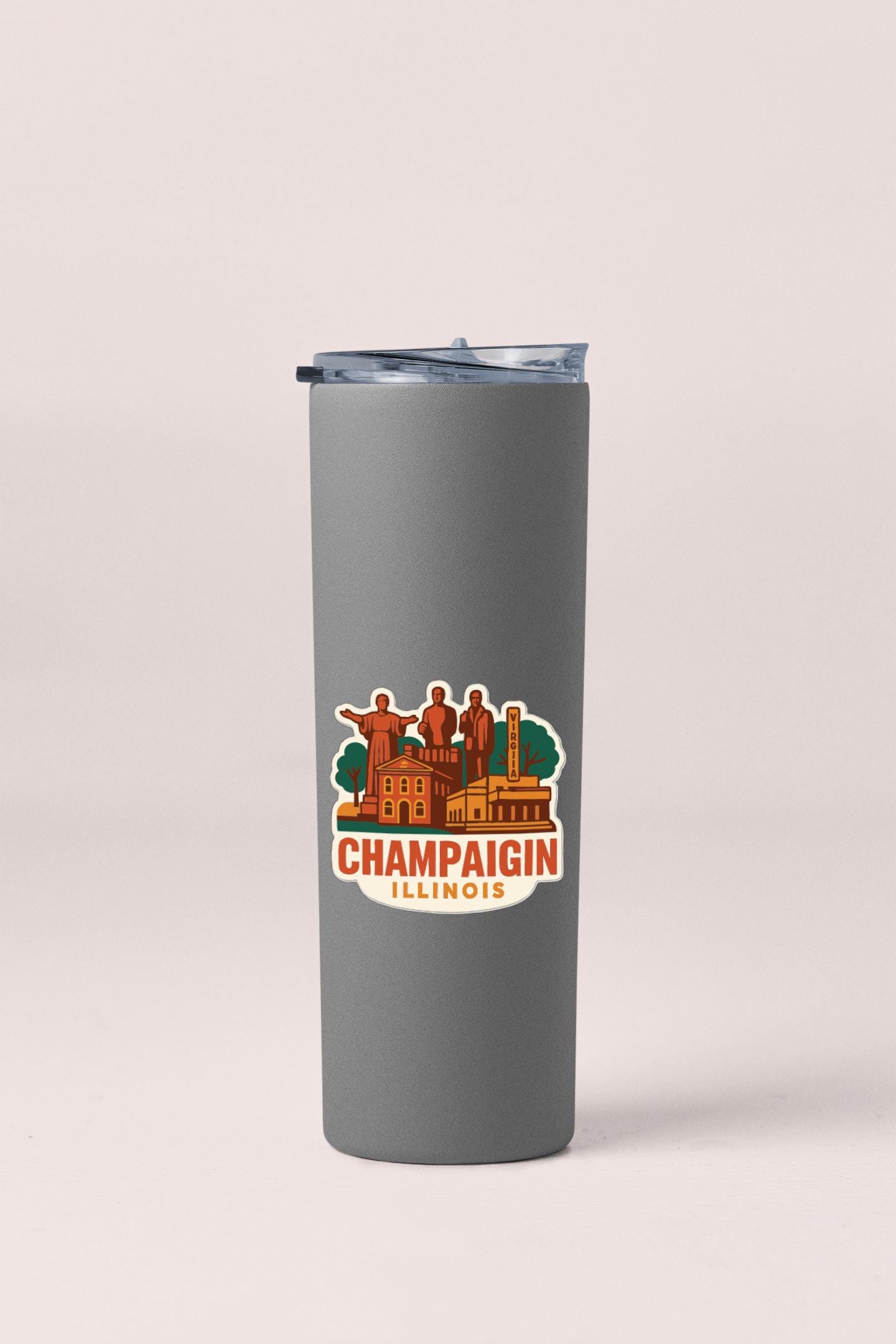 A gray insulated tumbler with a printed sticker depicting the Champaign, Illinois state capital.