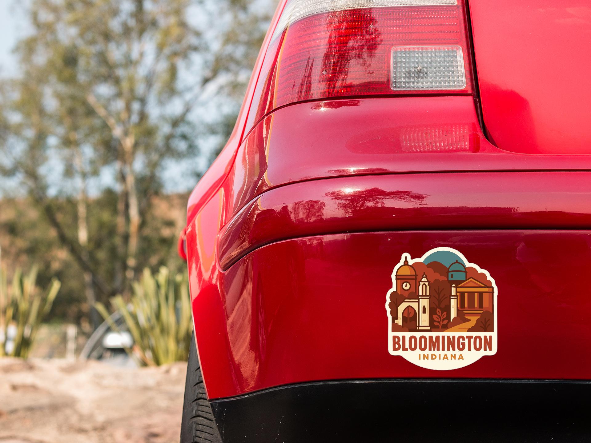 the rear end of a red car with a sticker on the back window that says "Bloomsington, Indiana".