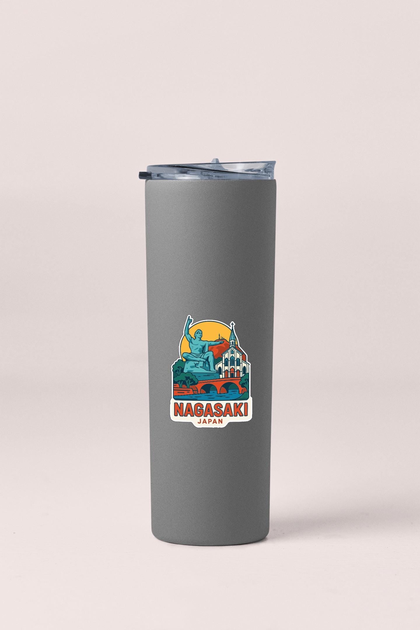 A gray insulated tumbler with a sticker depicting a landmark in Japan.