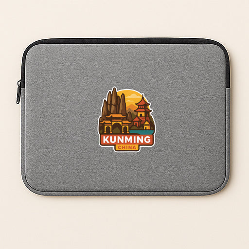 A gray laptop sleeve with a sticker depicting a cityscape and the text "KUNMING CHINA" printed on it.