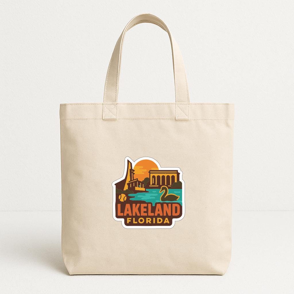 A beige tote bag with a printed design depicting a scenic view of Lakeland, Florida.
