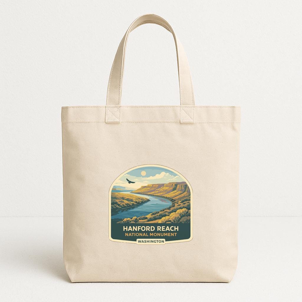 A beige tote bag with a printed label that says "HANFORD REACH NATIONAL MONUMENT WASHINGTON".