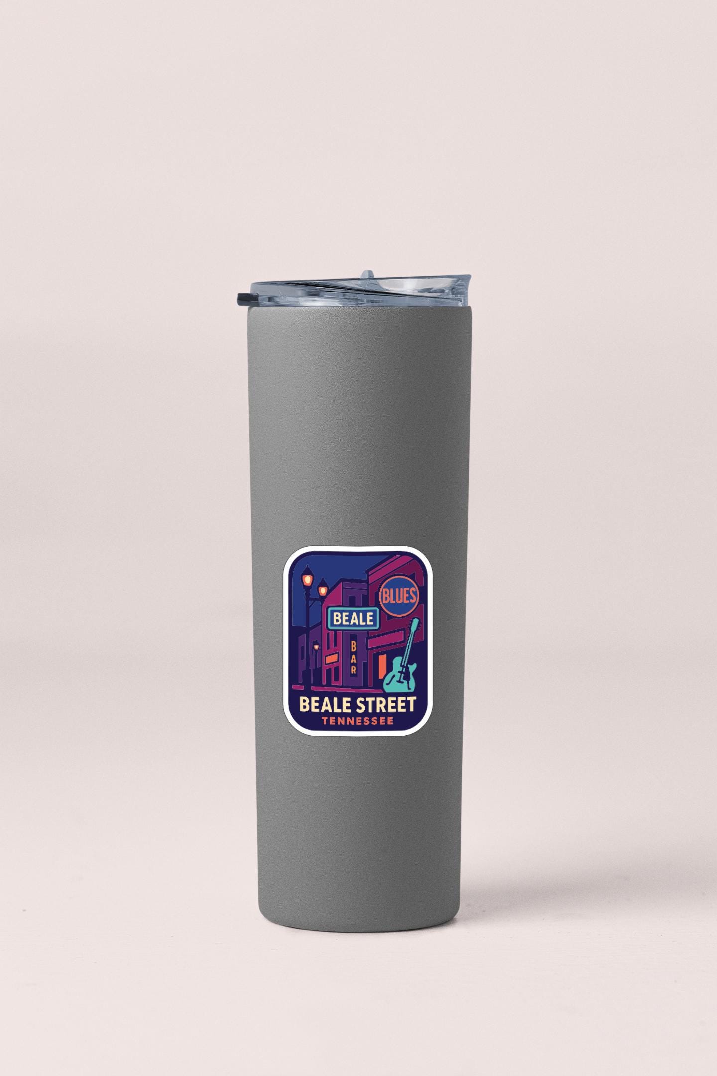 A gray insulated tumbler with a sticker depicting a street scene and the text "Beale Street Tennessee".