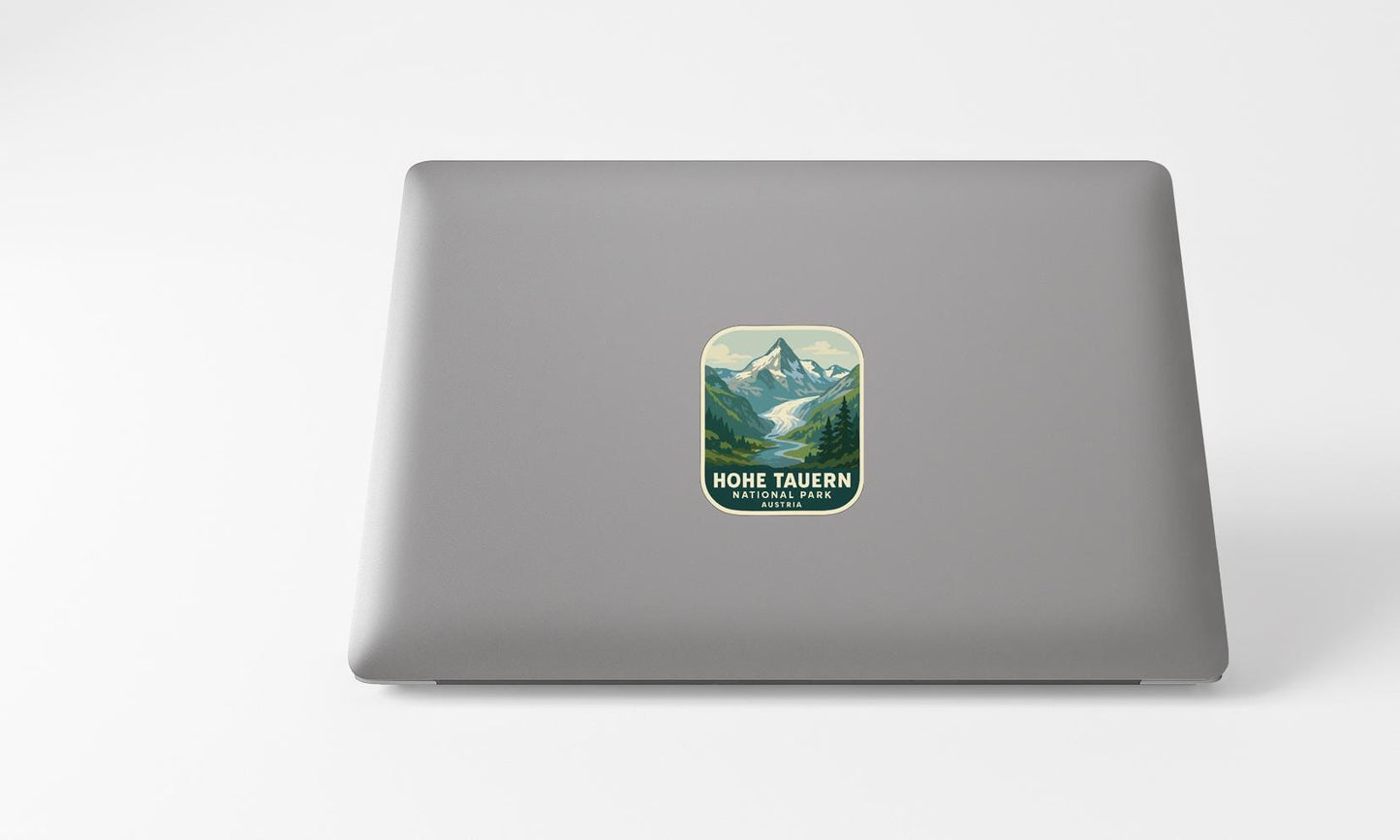 A sticker with a mountain landscape on a laptop.
