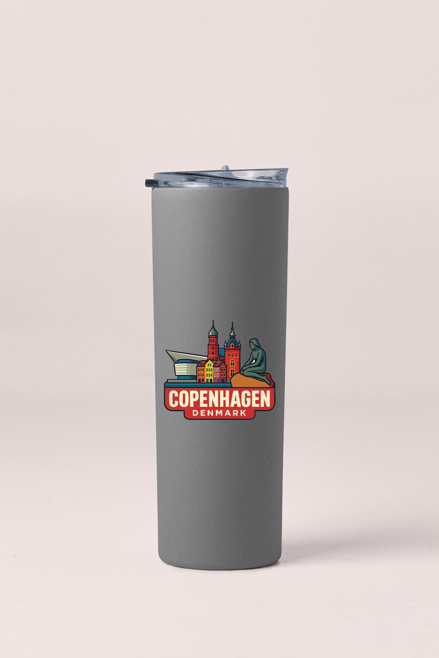 a travel mug with a picture of a city on it