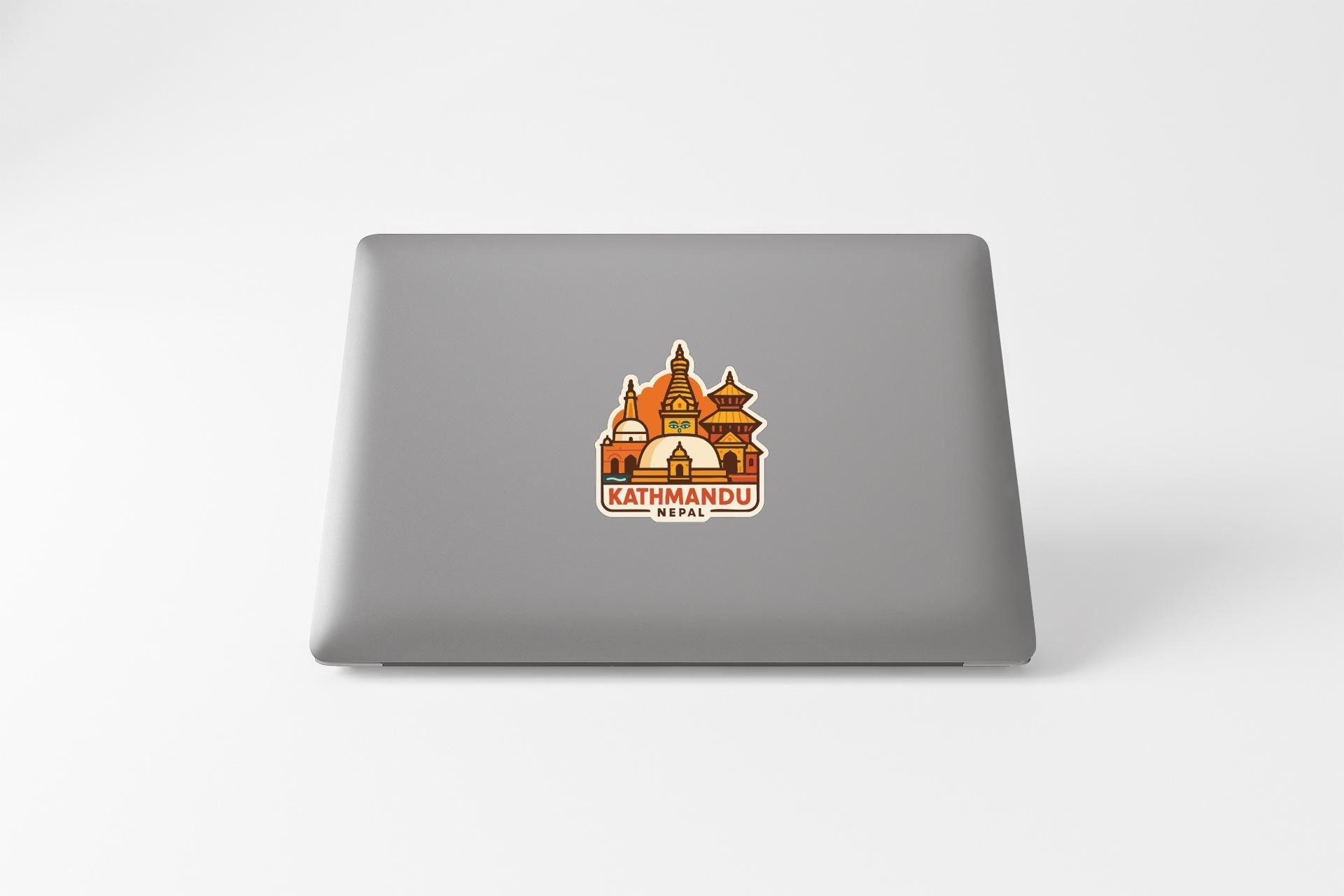 a sticker of a temple on the back of a laptop.