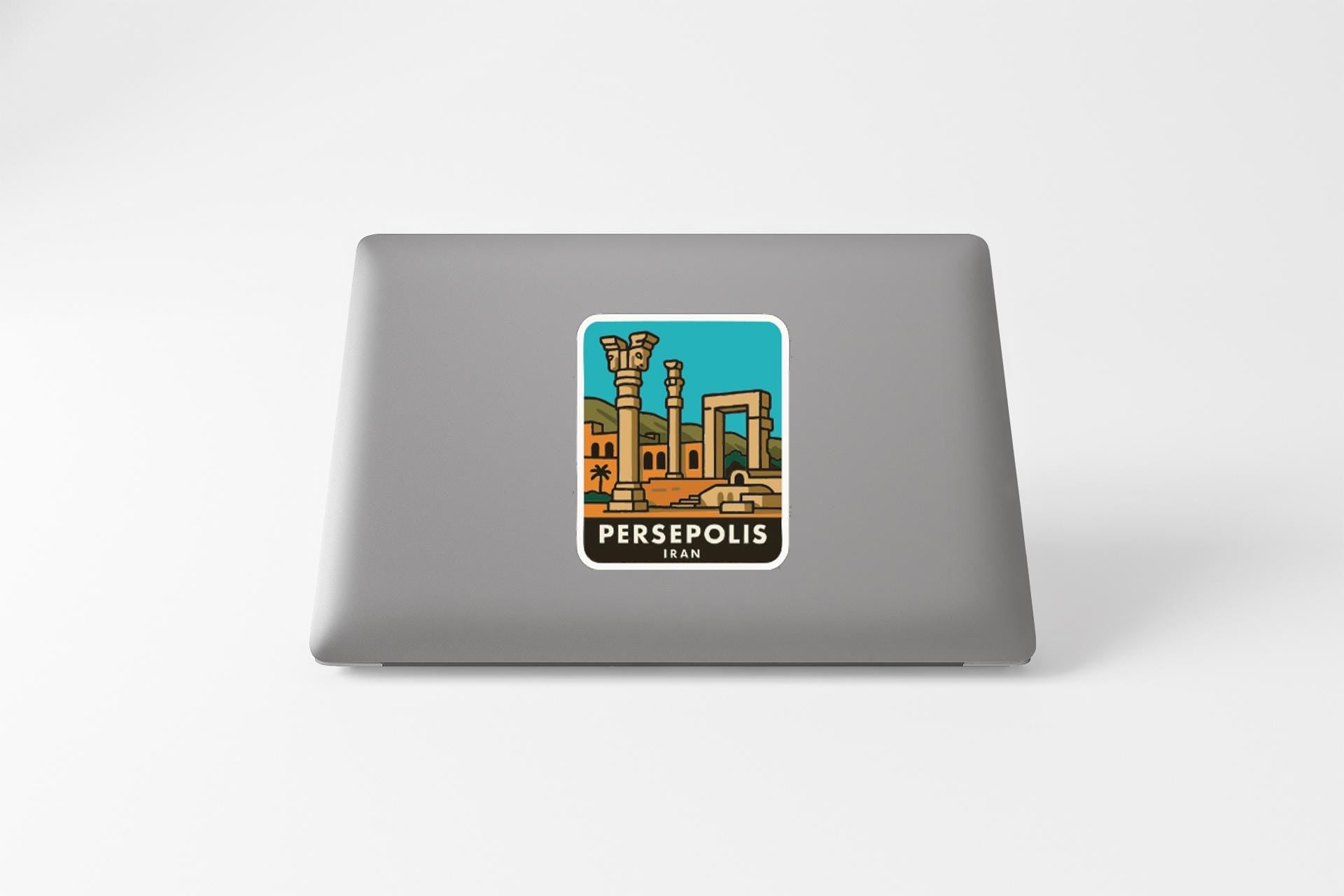 a sticker or decal of a cityscape on the back of a laptop computer.