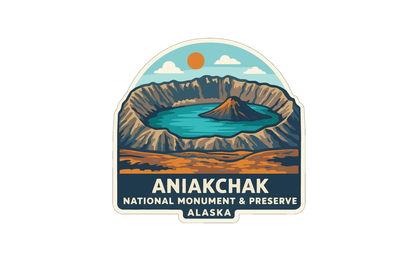 a sticker or label with a stylized illustration of a natural landscape, including mountains, a lake, and a sun. The text "ANIAKCHAK NATIONAL MONUMENT & PRESERVE ALASKA" is prominently displayed, indicating that this is a logo or emblem for the National Monument and Preserve in Alaska.