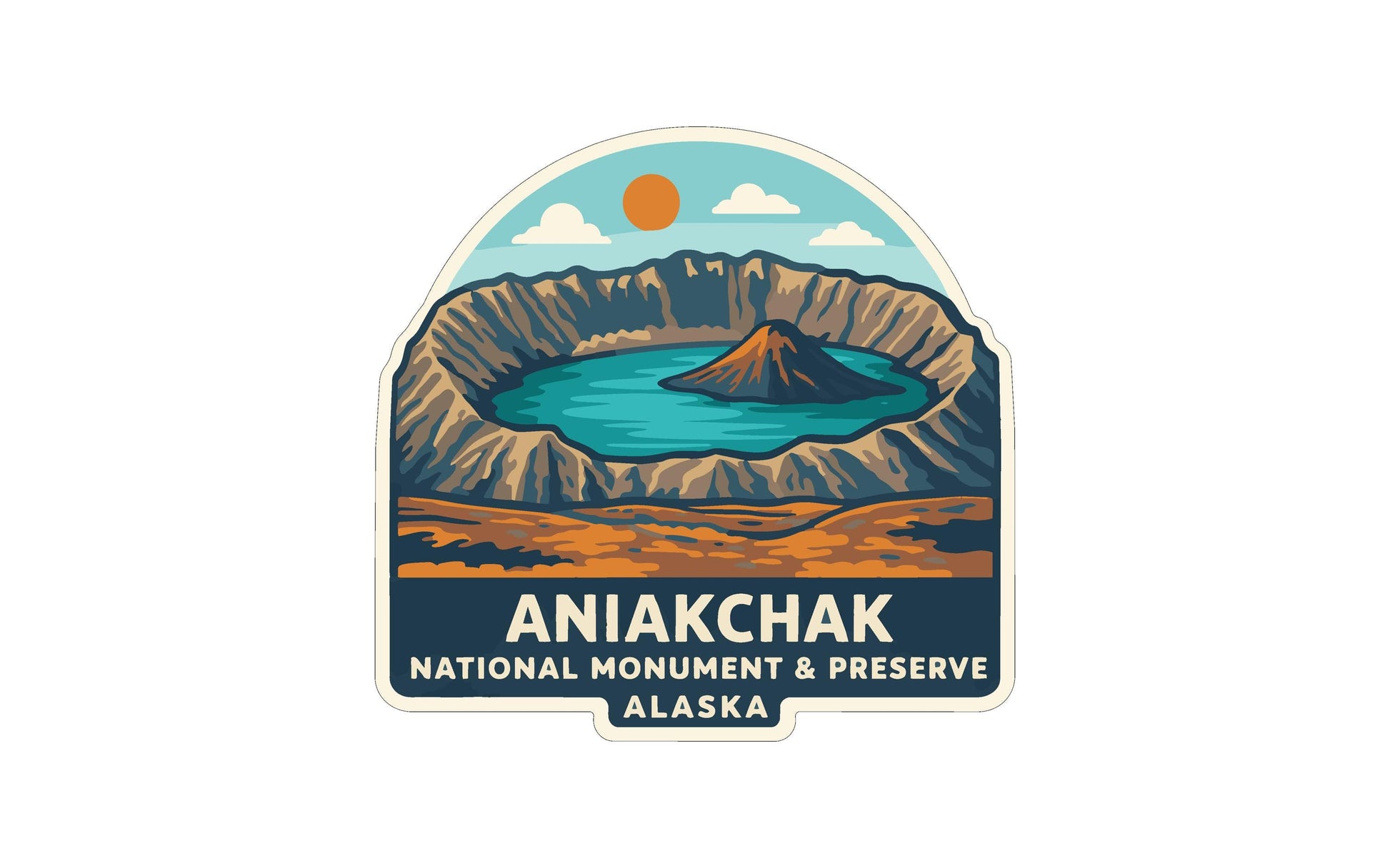a sticker or label with a stylized illustration of a natural landscape, including mountains, a lake, and a sun. The text "ANIAKCHAK NATIONAL MONUMENT & PRESERVE ALASKA" is prominently displayed, indicating that this is a logo or emblem for the National Monument and Preserve in Alaska.