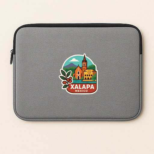 A gray laptop sleeve with a colorful sticker depicting a cityscape and the text "XALAPA MEXICO" printed on it.