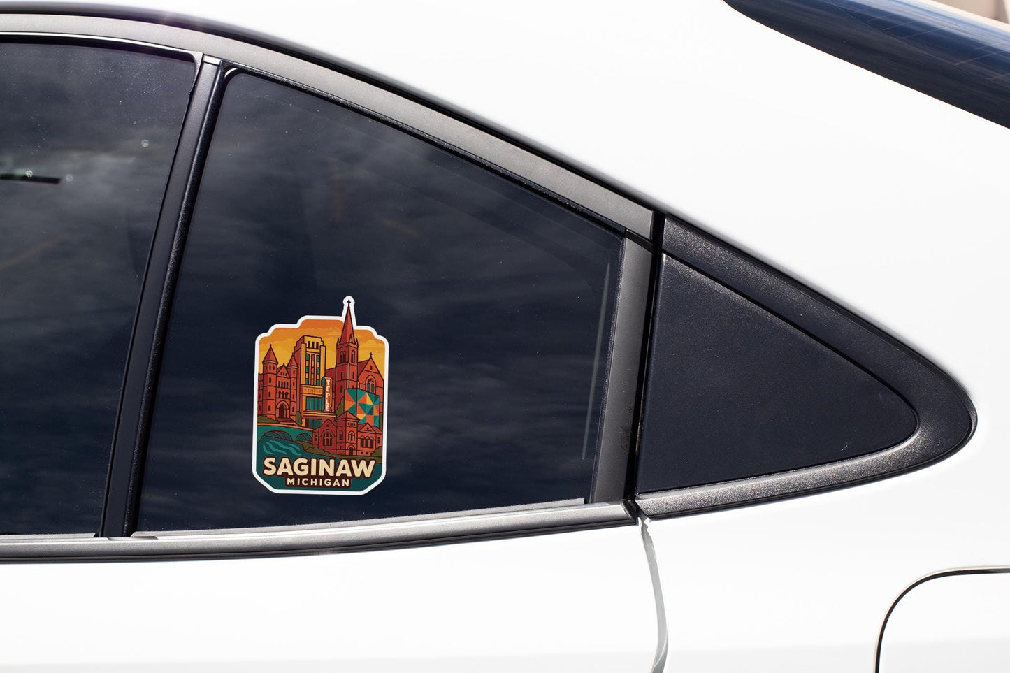 A sticker on the side of a car window, depicting a city skyline with the text "Saginaw, Michigan" printed on it.