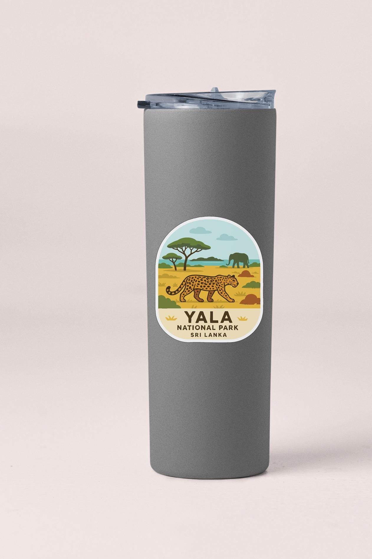 A gray tumbler with a label that features an illustration of a leopard and the text "YALA NATIONAL PARK SRI LANKA".