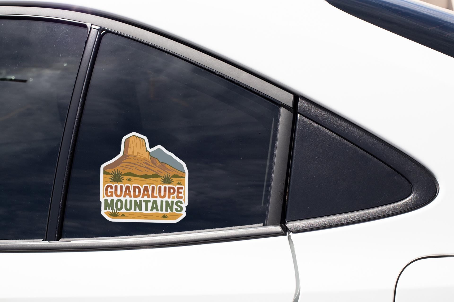 A sticker on the side of a car window that says "GUADALUPE MOUNTAINS".