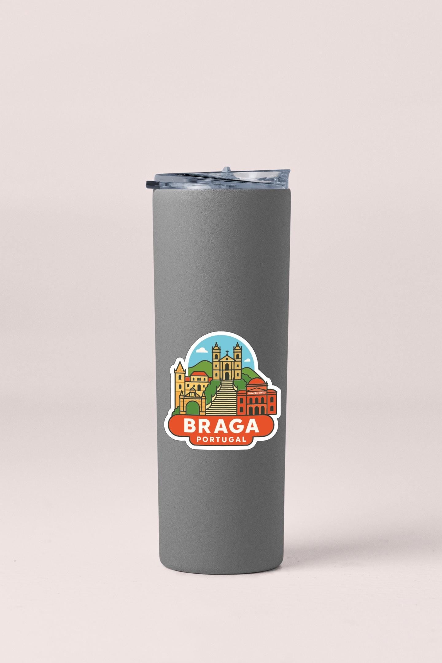 A gray insulated tumbler with a sticker depicting the city of Braga, Portugal.