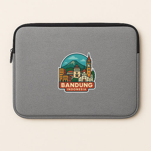 A gray laptop sleeve with a sticker depicting the city of Bandung, Indonesia.