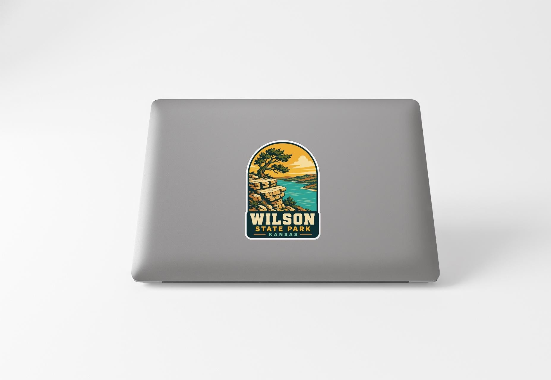 A sticker with a scenic landscape of Wilson State Park, featuring a cliff overlooking a lake.