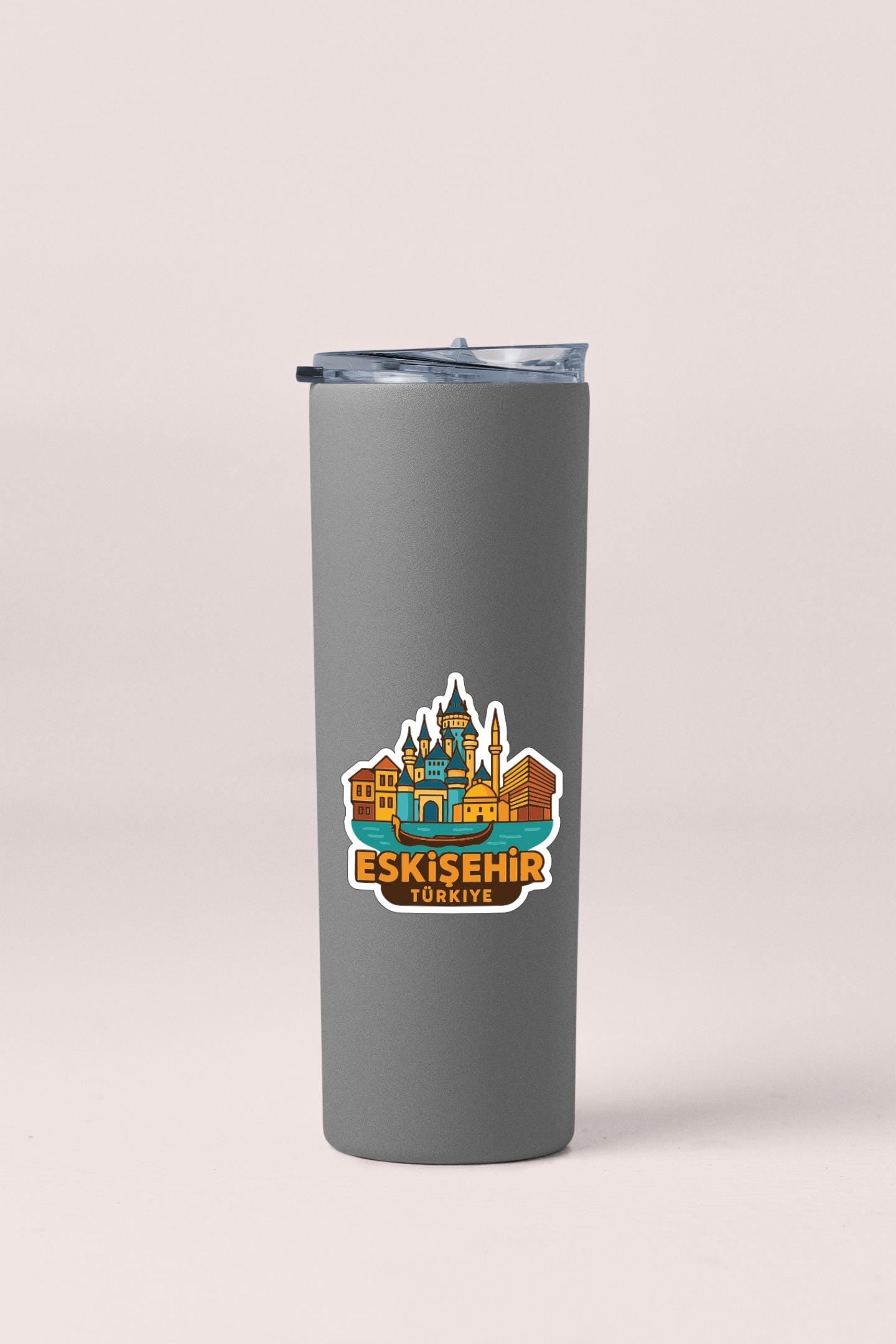 A gray insulated tumbler with a sticker depicting the skyline of Istanbul, Turkey.