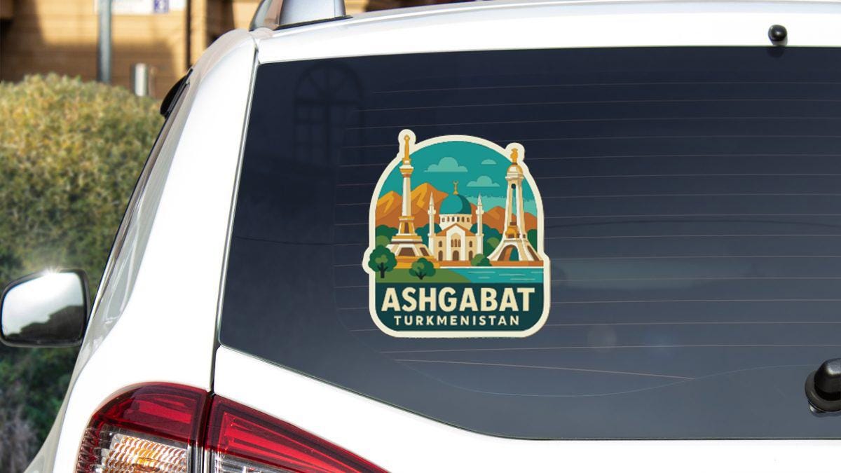 A sticker on the rear window of a car, depicting the skyline of Ashgabat, Turkmenistan.