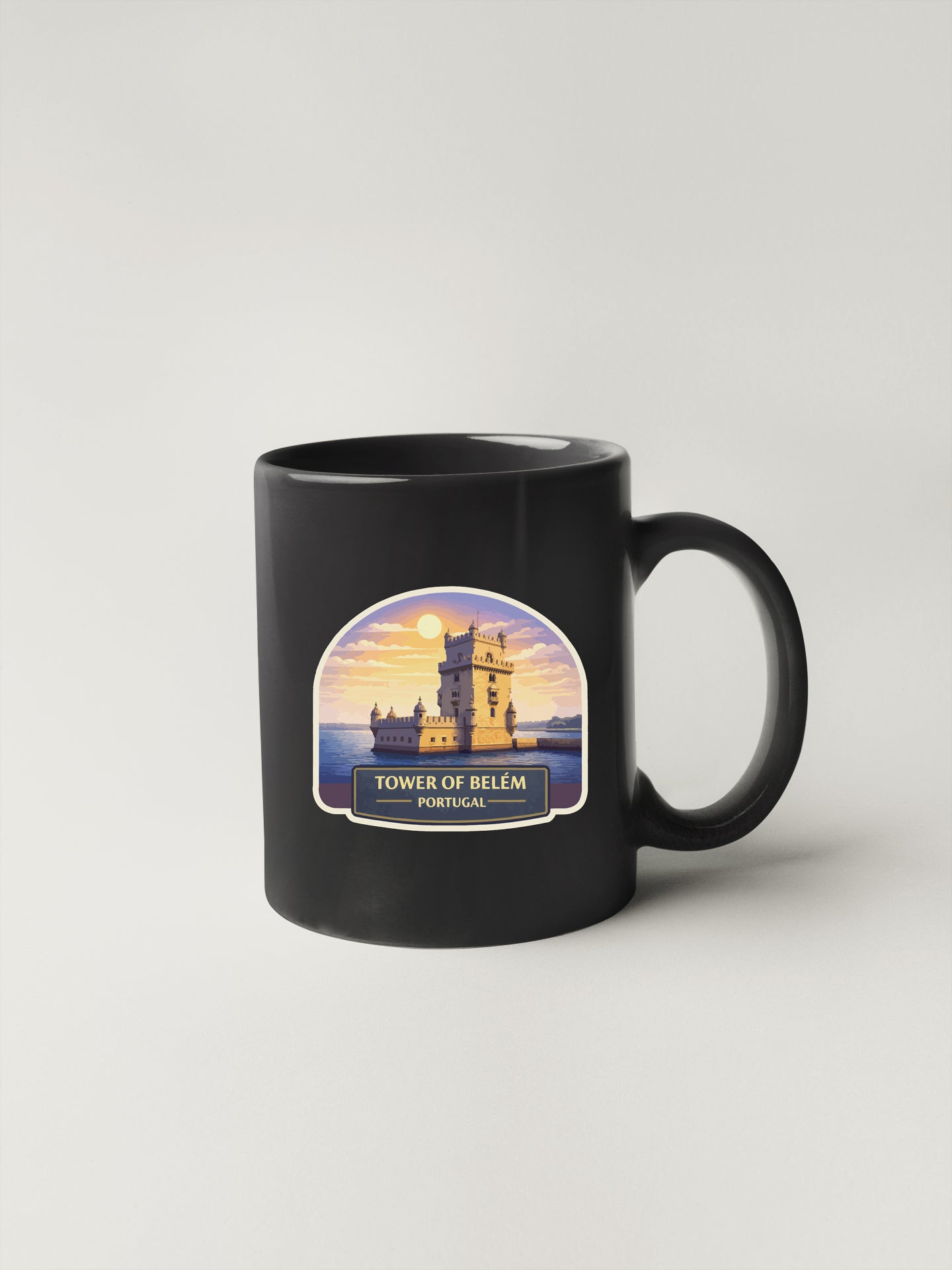 A black coffee mug with a printed image of the Tower of Belém, a famous landmark in Portugal.
