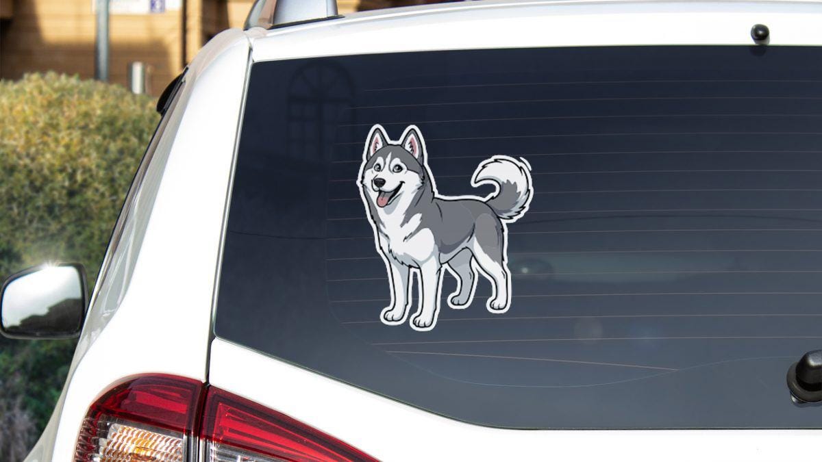 A sticker of a husky dog is displayed on the rear window of a white car.