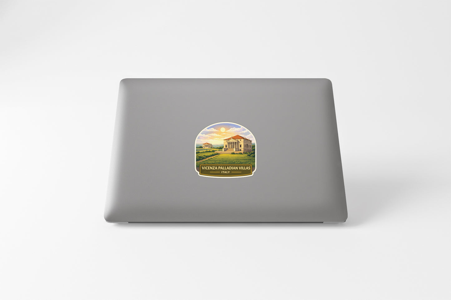 a sticker with a scenic landscape on the back of a laptop computer.