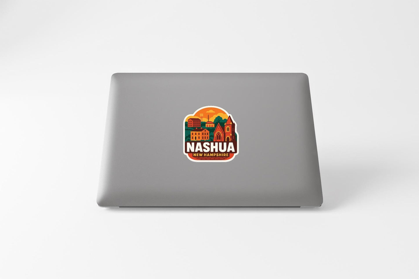 A sticker on the back of a laptop displaying the text "NASHUA NEW ORLEANS" along with an illustration of a cityscape.
