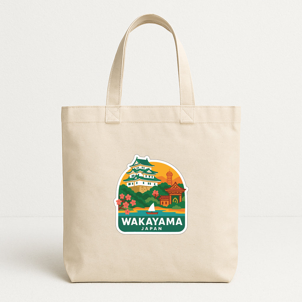 A beige tote bag with a printed design featuring a castle and other landmarks, along with the text "Wakayama Japan".